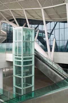 Glass elevator and escalator Stock Photos
