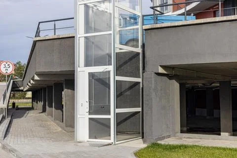 Glass elevator for disabled and disabled people at the entrance to a modern 写真素材