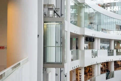 Glass elevator inside modern atrium at Yeltsin Center. Fragment of interior Stock Photos