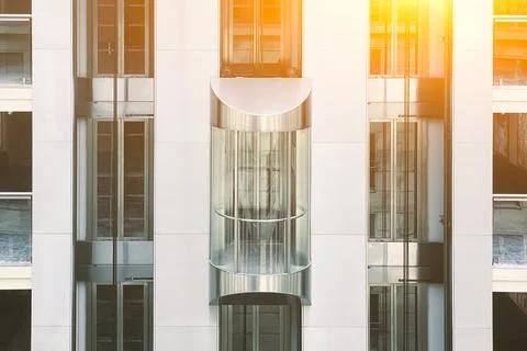 Glass elevator in a modern building, elevator in a business center Stock Photos