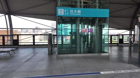 A glass elevator stands on a modern train platform. Stock Footage 333662763