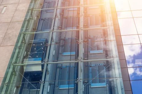 Glass elevators outside the skyscraper building, business architecture. Fotos Stock