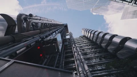 Glass elevators travelling up and down the outside of the Lloyds building Stock Footage 297186760