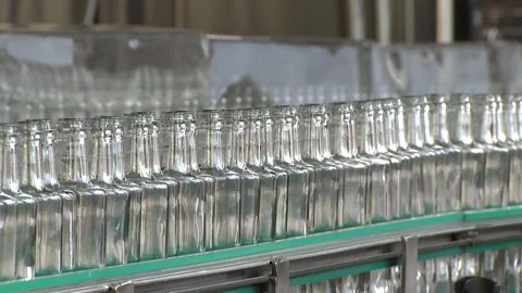 Glass empty bottles are moving along the conveyor, the average plan Video stock 97181270