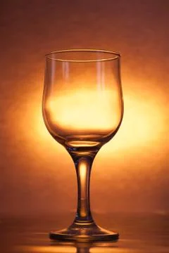 The glass is empty on a bright yellow background, Stock Photos