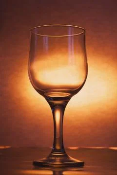 The glass is empty on a bright yellow background, Stock Photos