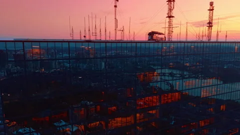 Glass facade of 200 Clarendon skyscraper reflects the cityscape. Pink sky in the Stock Footage 343662692