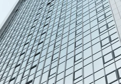 Glass facade of building forms grid pattern against sky. Modern architecture Stock Photos