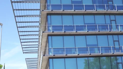 Glass facade building with multiple balconies against bright sky Video stock 336558675