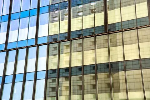 Glass facade of a modern building with reflection of the sky Stockfoto's
