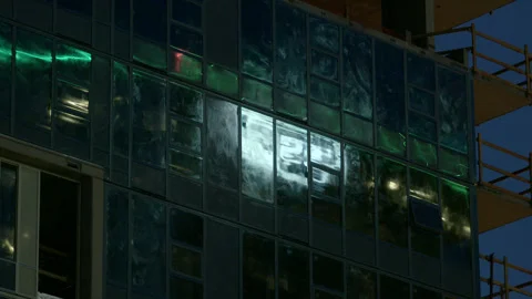 Glass Facade of Modern Building Under Construction at Night Stock Footage 344612772