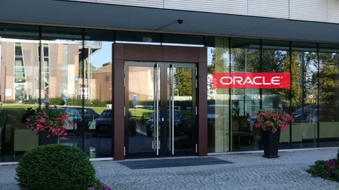 Glass facade of a modern office building with Oracle Corporation logo. Editorial Stock Footage 80660411