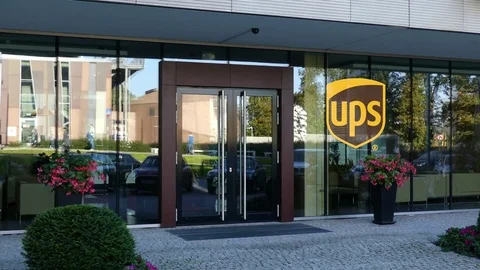 Glass facade of a modern office building with United Parcel Service UPS logo Stock Footage 80661109