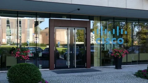Glass facade of a modern office building with Cisco Systems logo. Editorial 3D Stock Footage