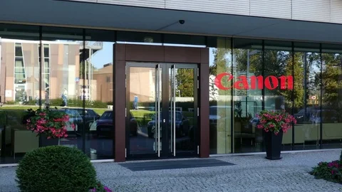 Glass facade of a modern office building with Canon Inc. logo. Editorial 3D Video stock 80666214