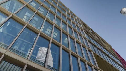 Glass facade of modern office building with reflection, low angle skyscraper Vídeo Stock 342026701