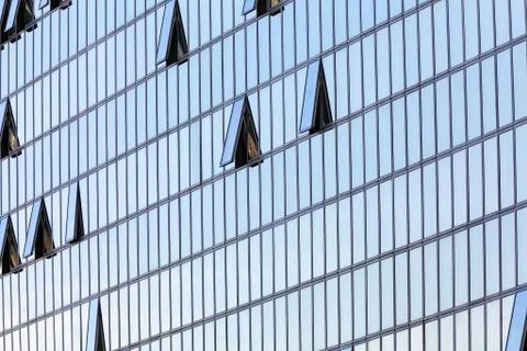 Glass facade with opened windows Stock Photos