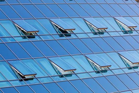 Glass facade with opened windows Stock Photos