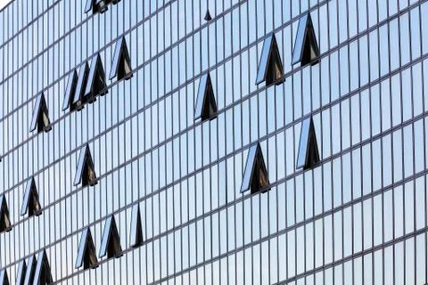 Glass facade with opened windows Stock Photos