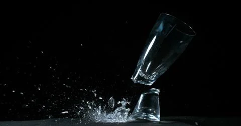 Glass Falling and exploding on Black Background Stock Photos