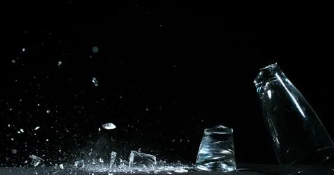 Glass Falling and exploding on Black Background Stock Photos