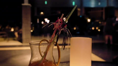 A glass filled with alcoholic beverage on a table Stock Footage 65554797