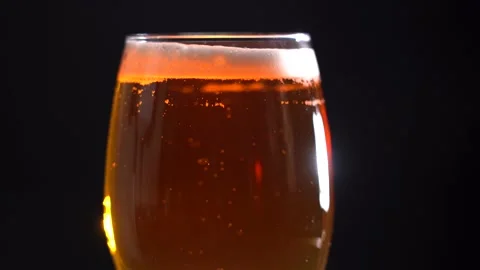 Glass Filled With Light Beer. Light Beer Into a Glass on a Dark Background Stock Footage 164545009