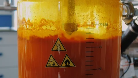 Glass flasks with orange liquid are mixed, equipment of chemical laboratory. Stock Footage 123272864