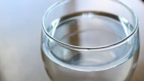 Glass of fresh drinking water on the table Stock Footage 162448735