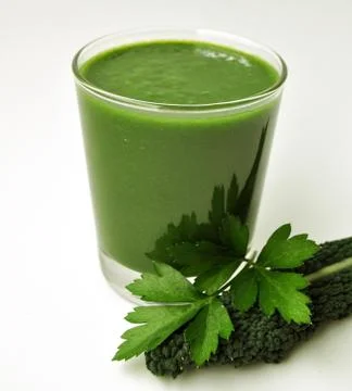 A glass of fresh green smoothie with parsley and kale Stock Photos
