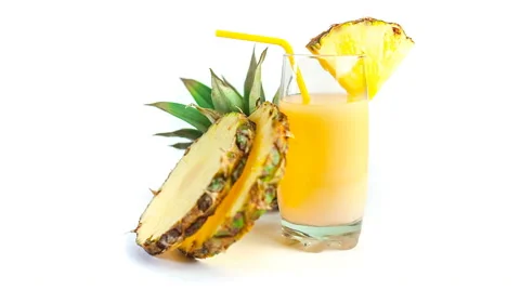 Glass of fresh pineapple juice with two slices of pineapple Stock Footage 63079562