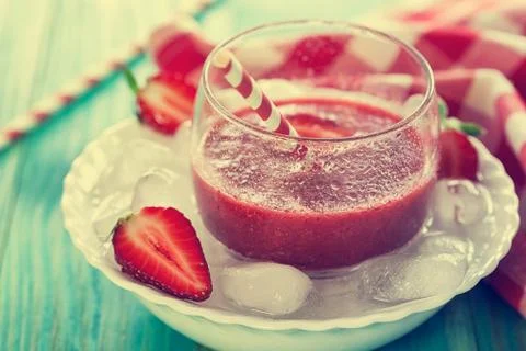 A Glass of fresh strawberry smoothie on ice cubes Stock Photos