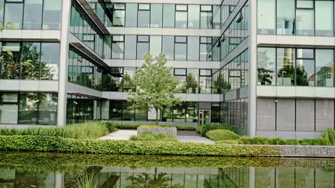 Glass fronted office block reflected in water Stock Footage 88039629