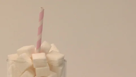 A glass full of sugar with a straw Stock Footage 117035796