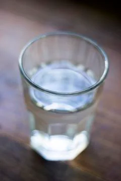 Glass full of water over wooden table Stock Photos