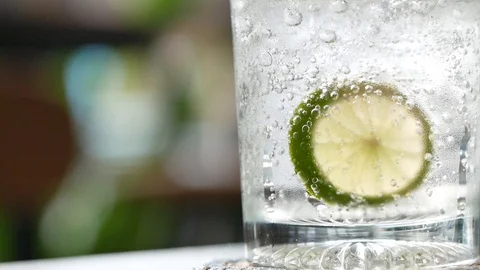 Glass of gin tonic with lime, refreshing cocktail, with copy space on left Stock Footage 106373246