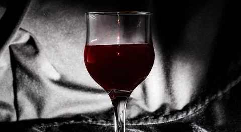 Glass glass of red wine on a highlighted black background. Stock Photos