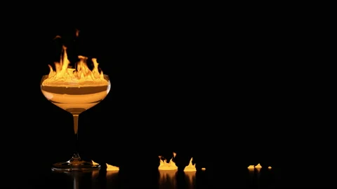 Glass goblet with fire inside and splash burning on the table. Stock Footage 155191355