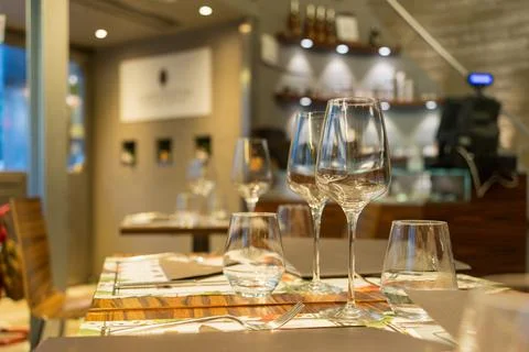 Glass goblets on the table in the restaurant selective focus, pleasant evenin Stock Photos