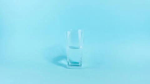 The glass is half empty or full. A glass transparent glass is filled with wat Stock Photos