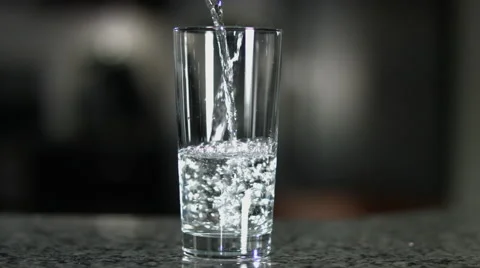 Glass Half Empty or Half Full Pour Slow Motion Stock Footage 60632423