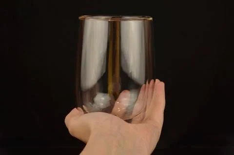Glass in a hand Stock Photos