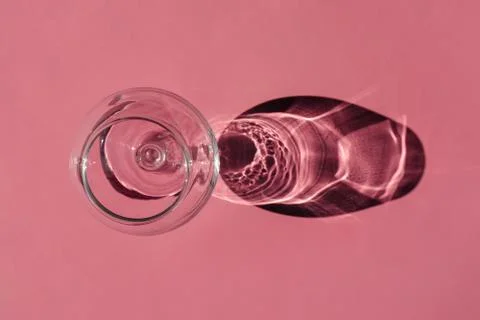 A glass with a hard shadow on a plain background. the view from the top. blank 스톡 사진