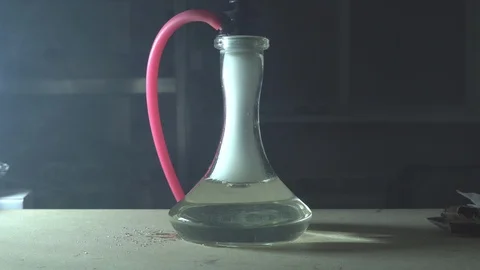 Glass hookah on table on smoke in slow motion Stock Footage 102532448