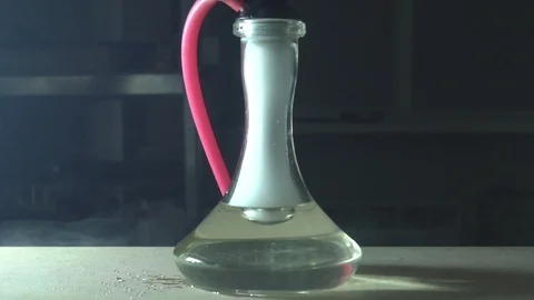 Glass hookah on table on smoke in slow motion Stock Footage 102532621
