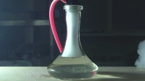 Glass hookah on table on smoke in slow motion Stock Footage 102532672