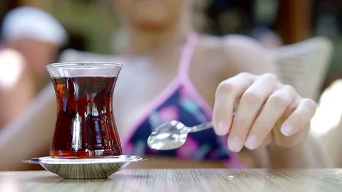 The glass of hot tea ion a table in old fashioned tea house , enjoying their Vidéo 91084964