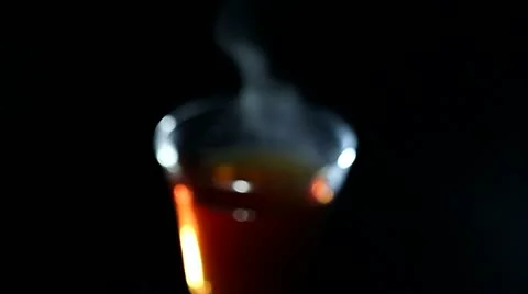 Glass of hot tea in rotation. Blurred scene Stock Footage