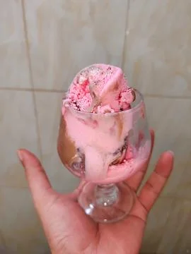 A glass of ice cream in hand Stock Photos