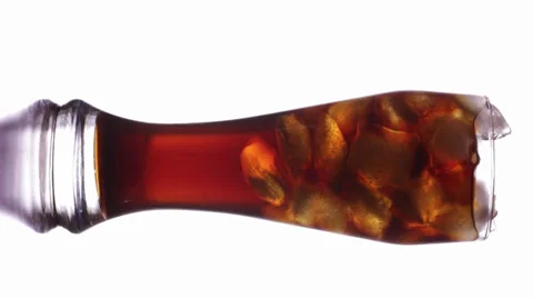 Glass with  ice cubes in cola background Stock Footage 34311258